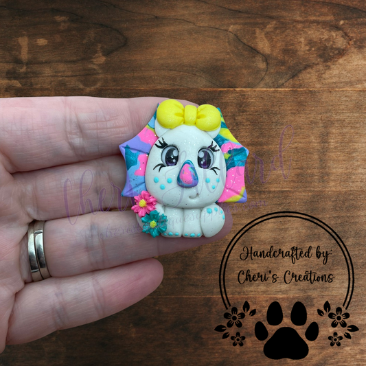Rainbow Triceratops Bow Center – Handmade Polymer Clay Embellishment